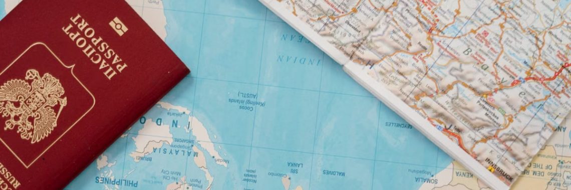 Flat lay of a passport and map, symbolizing travel adventure and exploration.